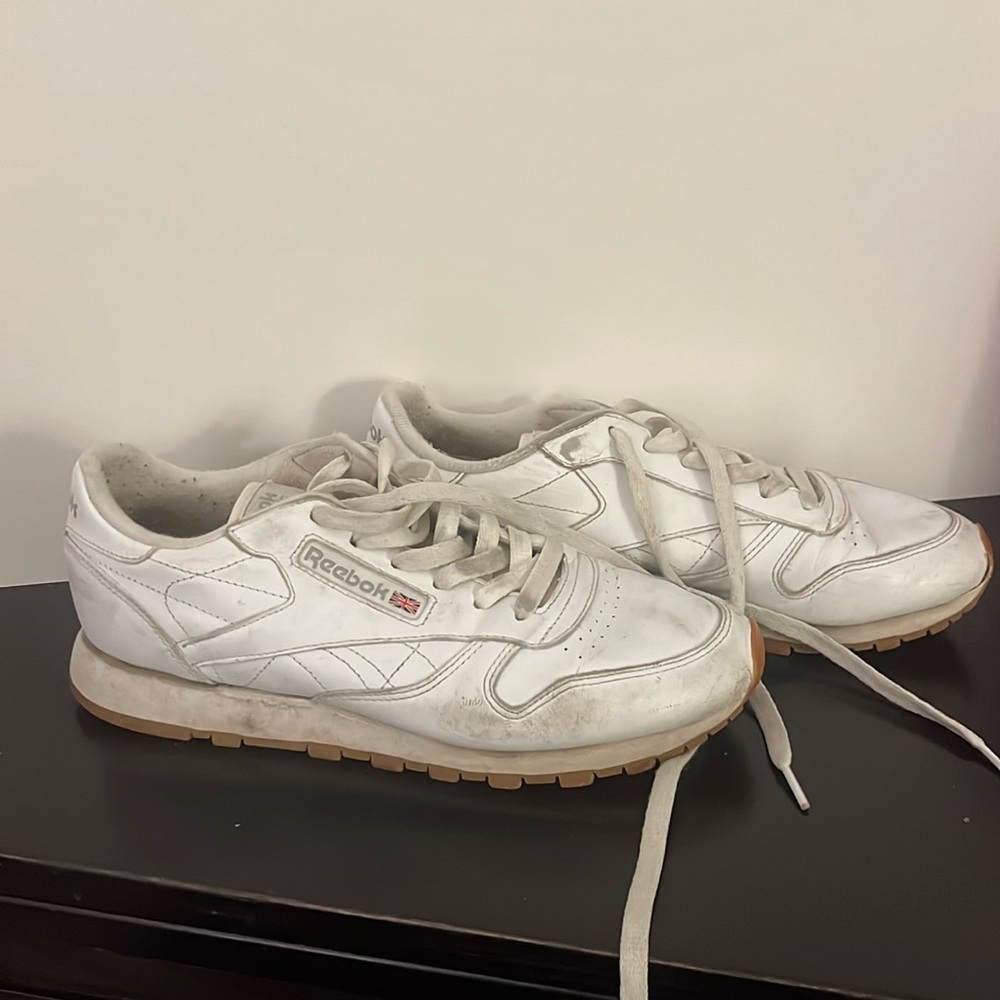 Well worn white Reebok sneakers
